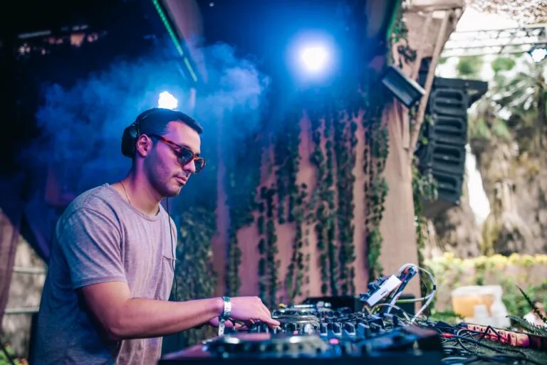 DJ bajo luz azul y humo